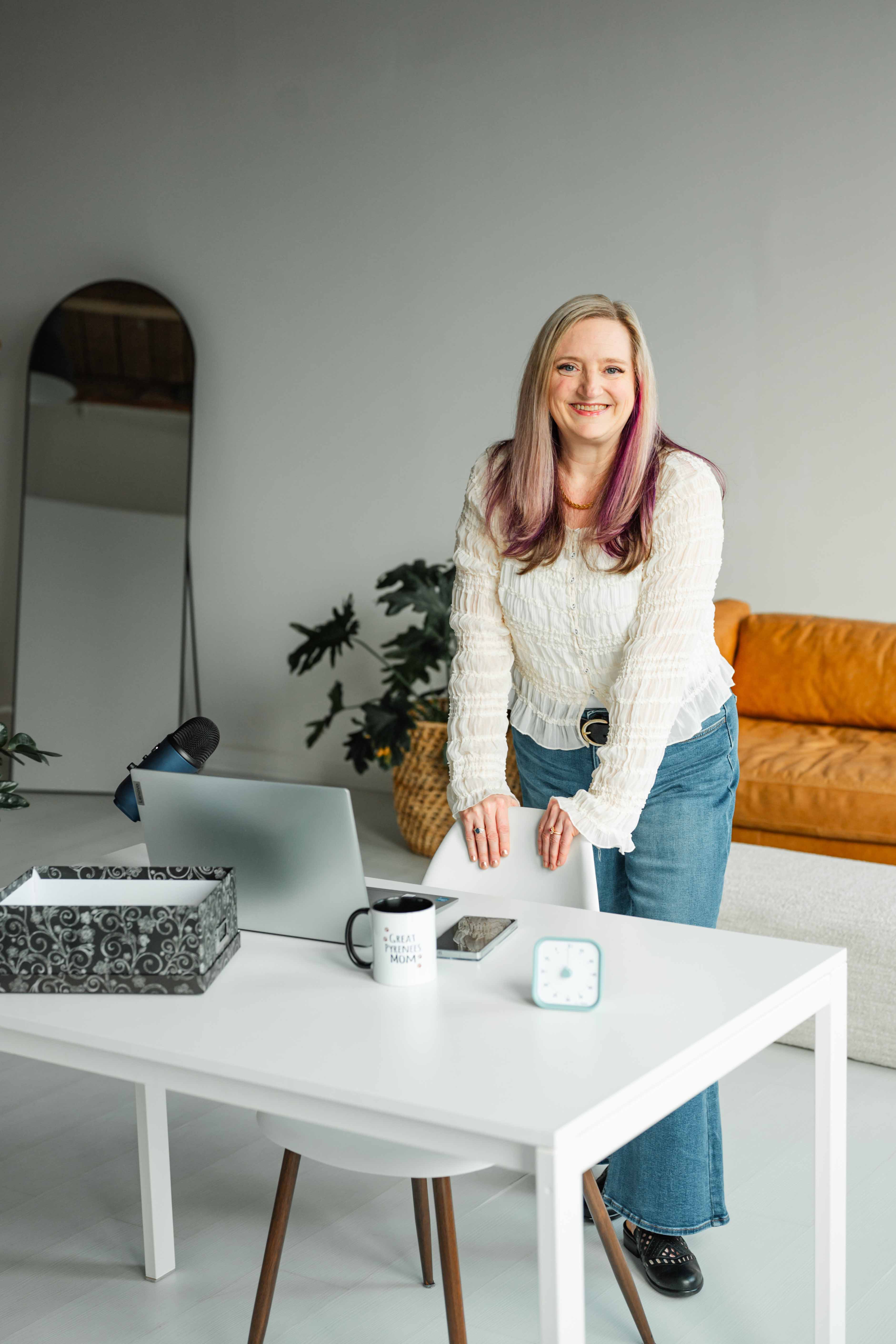 ADHD Organizer and Decluttering Coach, Lorinda Dishington Ortiz, standing at desk in an organized, tidy office.